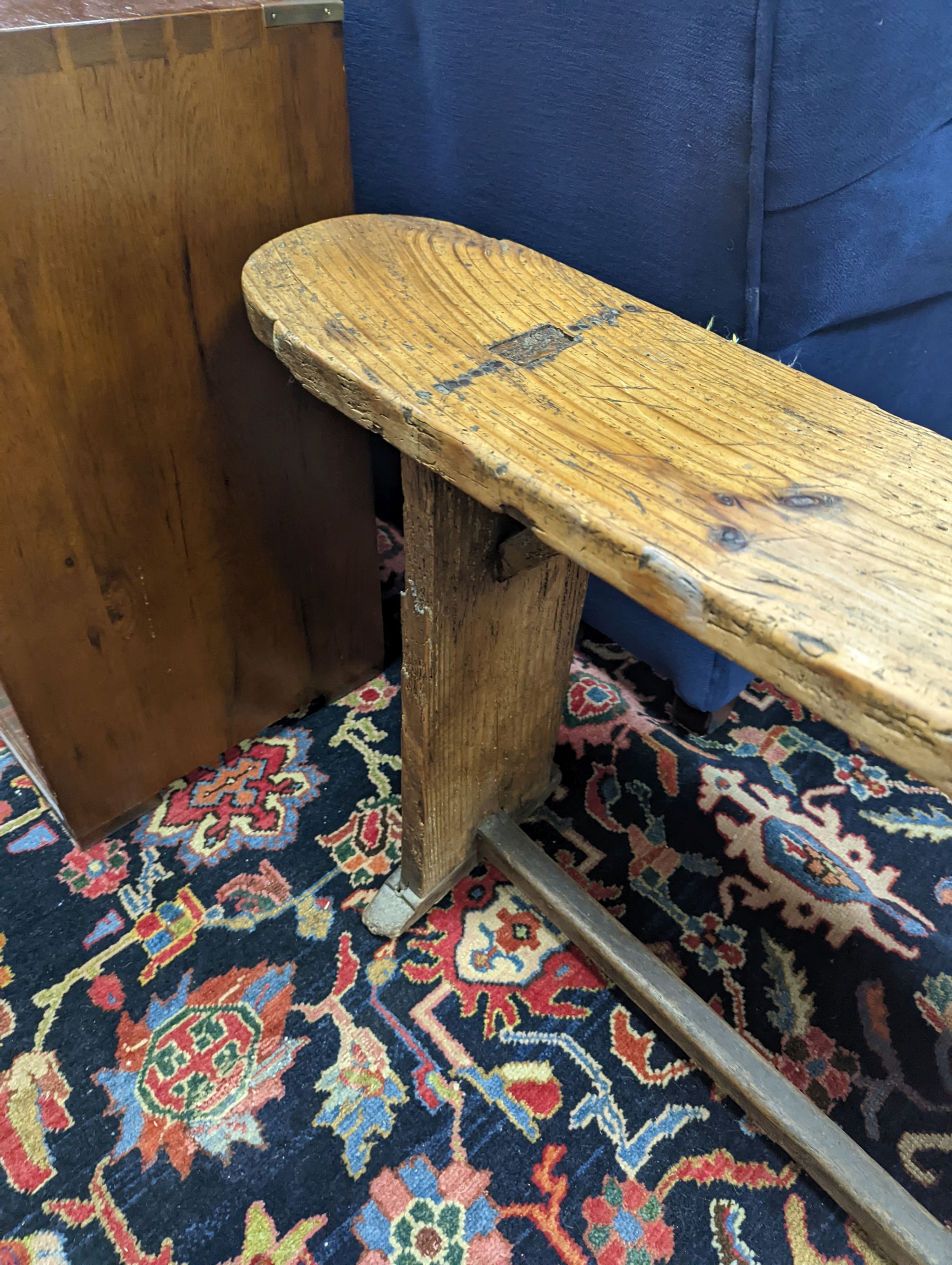 An 18th century pine bench, length 162cm, height 49cm